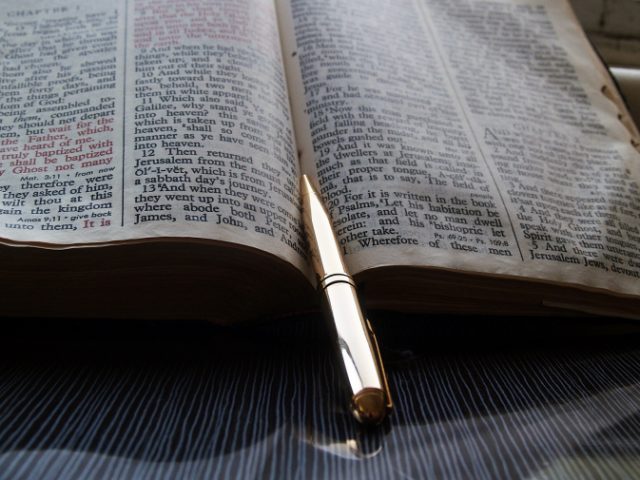 Pen resting on a bible
